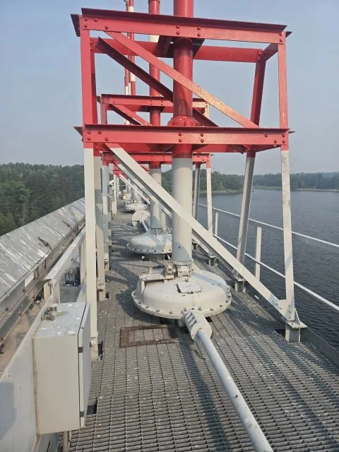 Gate hoist drives and gantry framing along the dam deck