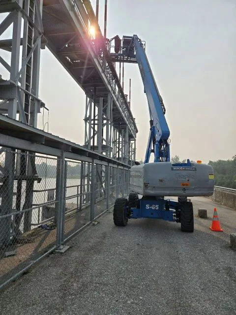 Boom lift positioned for access to the overhead structure